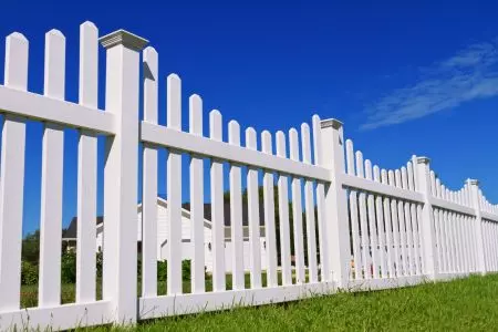 picket white vinyl fence in port st lucie with green grass around